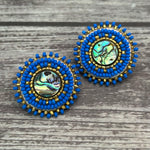 Handmade drop earrings with abalone shell button, seed beads, 24kt gold beads, hide backing, and 925 silver studs, 1 inch long.