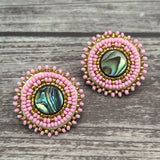 Handmade drop earrings with abalone shell button, seed beads, 24kt gold beads, hide backing, and 925 silver studs, 1 inch long.