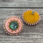 Handmade drop earrings with abalone shell button, seed beads, 24kt gold beads, hide backing, and 925 silver studs, 1 inch long.