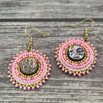 Handmade drop earrings with abalone shell button, seed beads, 24kt gold beads, hide backing, and 18kt gold hooks, 2” long.