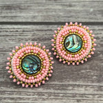 Handmade drop earrings with abalone shell button, seed beads, 24kt gold beads, hide backing, and 925 silver studs, 1 inch long.
