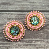Handmade drop earrings with abalone shell button, seed beads, 24kt gold beads, hide backing, and 925 silver studs, 1 inch long.