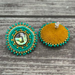 Handmade drop earrings with abalone shell button, seed beads, 24kt gold beads, hide backing, and 925 silver studs, 1 inch long.