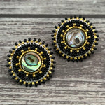 Handmade drop earrings with abalone shell button, seed beads, 24kt gold beads, hide backing, and 925 silver studs, 1 inch long.