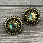 Handmade drop earrings with abalone shell button, seed beads, 24kt gold beads, hide backing, and 925 silver studs, 1 inch long.