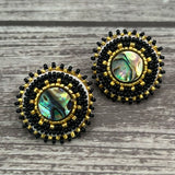 Handmade drop earrings with abalone shell button, seed beads, 24kt gold beads, hide backing, and 925 silver studs, 1 inch long.