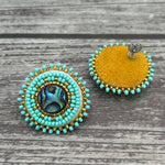 Handmade drop earrings with abalone shell button, seed beads, 24kt gold beads, hide backing, and 925 silver studs, 1 inch long.